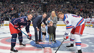 COLUMBUS, OH - JANUARY 13: Nick Foligno #71 of the Columbus Blue Jackets and Marc Staal #18 of the New York Rangers pose with Rick Nash and his family for a ceremonial puck drop prior to a game on January 13, 2019 at Nationwide Arena in Columbus, Ohio. (Photo by Jamie Sabau/NHLI via Getty Images)