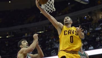 Oct 14, 2014; Cleveland, OH, USA; Cleveland Cavaliers forward Kevin Love (0) drives to the basket beside Milwaukee Bucks forward Ersan Ilyasova (left) in the first quarter at Quicken Loans Arena. Mandatory Credit: David Richard-USA TODAY Sports