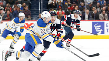 Mar 15, 2023; Washington, District of Columbia, USA; Buffalo Sabres right wing Jack Quinn (22) skates with the puck as Washington Capitals right wing T.J. Oshie (77) chases in the first period at Capital One Arena. Mandatory Credit: Geoff Burke-USA TODAY Sports