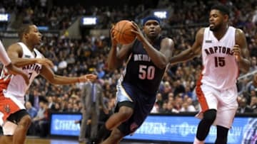 Nov 19, 2014; Toronto, Ontario, CAN; Memphis Grizzlies forward Zach Randolph (50) cuts toward the basket between Toronto Raptors guard Kyle Lowry (7) and forward Amir Johnson (15) during the second half of the Grizzlies 96-92 loss at Air Canada Centre. Mandatory Credit: Dan Hamilton-USA TODAY Sports