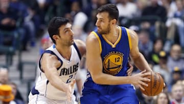 Dec 30, 2015; Dallas, TX, USA; Golden State Warriors center Andrew Bogut (12) dribbles as Dallas Mavericks center Zaza Pachulia (27) defends during the first half at American Airlines Center. Mandatory Credit: Kevin Jairaj-USA TODAY Sports