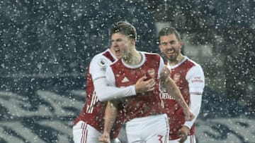 Arsenal's Scottish defender Kieran Tierney (C) celebrates after scoring the opening goal during the English Premier League football match between West Bromwich Albion and Arsenal at The Hawthorns stadium in West Bromwich, central England, on January 2, 2021. (Photo by Rui Vieira / POOL / AFP) / RESTRICTED TO EDITORIAL USE. No use with unauthorized audio, video, data, fixture lists, club/league logos or 'live' services. Online in-match use limited to 120 images. An additional 40 images may be used in extra time. No video emulation. Social media in-match use limited to 120 images. An additional 40 images may be used in extra time. No use in betting publications, games or single club/league/player publications. / (Photo by RUI VIEIRA/POOL/AFP via Getty Images)