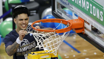 GREENSBORO, NORTH CAROLINA - MARCH 13: Michael Devoe #0 of the Georgia Tech Yellow Jackets cuts the net from the rim after defeating the Florida State Seminoles in the ACC Men's Basketball Tournament championship game at Greensboro Coliseum on March 13, 2021 in Greensboro, North Carolina. (Photo by Jared C. Tilton/Getty Images)
