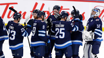 May 11, 2021; Winnipeg, Manitoba, CAN; Winnipeg Jets players celebrate on the ice after defeating the Vancouver Canucks at Bell MTS Place. Mandatory Credit: James Carey Lauder-USA TODAY Sports