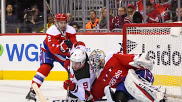 WASHINGTON, DC - NOVEMBER 30: New Jersey Devils left wing Taylor Hall (9) collides with Washington Capitals goaltender Braden Holtby (70) in the third period on November 30, 2018, at the Capital One Arena in Washington, D.C. (Photo by Mark Goldman/Icon Sportswire via Getty Images)