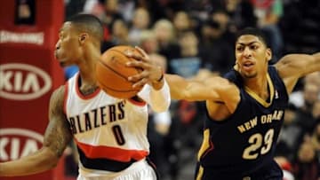Dec 21, 2013; Portland, OR, USA; New Orleans Pelicans power forward Anthony Davis (23) reaches in to try and steal the ball from Portland Trail Blazers point guard Damian Lillard (0) during the first quarter of the game at the Moda Center. Mandatory Credit: Steve Dykes-USA TODAY Sports