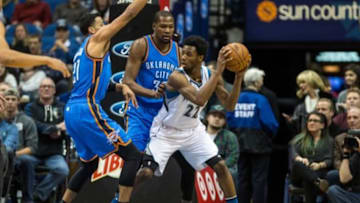 Jan 12, 2016; Minneapolis, MN, USA; Minnesota Timberwolves guard Andrew Wiggins (22) is guarded by Oklahoma City Thunder forward Kevin Durant (35) and guard Andre Roberson (21) at Target Center. The Thunder defeated the Timberwolves 101-96. Mandatory Credit: Brace Hemmelgarn-USA TODAY Sports