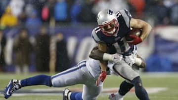 Jan 18, 2015; Foxborough, MA, USA; New England Patriots wide receiver Julian Edelman (11) is tackled by Indianapolis Colts inside linebacker Jerrell Freeman (50) during the fourth quarter in the AFC Championship Game at Gillette Stadium. Mandatory Credit: Greg M. Cooper-USA TODAY Sports
