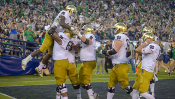 SAN DIEGO, CA - OCTOBER 27: Dexter Williams #2 of the Notre Dame Fighting Irish is lifted in celebration after scoring a touchdown in the 1st half against the Navy Midshipmen at SDCCU Stadium on October 27, 2018 in San Diego, California. (Photo by Kent Horner/Getty Images)