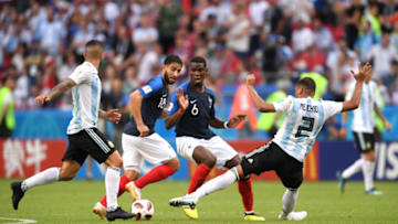 KAZAN, RUSSIA - JUNE 30: Paul Pogba and Nabil Fekir of France compete for the ball with Gabriel Mercado of Argentina during the 2018 FIFA World Cup Russia Round of 16 match between France and Argentina at Kazan Arena on June 30, 2018 in Kazan, Russia. (Photo by Laurence Griffiths/Getty Images)