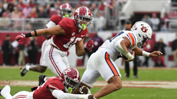 Auburn footballNov 26, 2022; Tuscaloosa, Alabama, USA; Alabama Crimson Tide linebacker Deontae Lawson (32) tackles Auburn Tigers running back Jarquez Hunter (27) at Bryant-Denny Stadium. Alabama won 49-27. Mandatory Credit: Gary Cosby Jr.-USA TODAY Sports