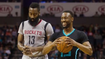 Mar 12, 2016; Charlotte, NC, USA; Charlotte Hornets guard Kemba Walker (15) smiles after drawing the foul call against Houston Rockets guard James Harden (13) in the first half at Time Warner Cable Arena. Mandatory Credit: Jeremy Brevard-USA TODAY Sports