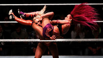 MUNICH, GERMANY - NOVEMBER 03: Charlotte Flair takes down Sascha Banks in their match during the WWE Live Munich event at Olympiahalle on November 3, 2016 in Munich, Germany. (Photo by Adam Pretty/Bongarts/Getty Images)