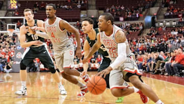 COLUMBUS, OH - FEBRUARY 23: A.J. Harris #12 of the Ohio State Buckeyes controls the ball against the Michigan State Spartans on February 23, 2016 at Value City Arena in Columbus, Ohio. (Photo by Jamie Sabau/Getty Images)