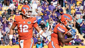 Nov 19, 2016; Baton Rouge, LA, USA; Florida Gators quarterback Austin Appleby (12) hands off to running back Jordan Scarlett (25) during the game against the LSU Tigers at Tiger Stadium. The Gators defeat the Tigers 16-10. Mandatory Credit: Jerome Miron-USA TODAY Sports