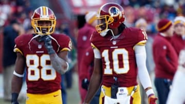 Dec 7, 2014; Landover, MD, USA; Washington Redskins quarterback Robert Griffin III (10) talks to Redskins wide receiver Pierre Garcon (88) on the sidelines against the St. Louis Rams at FedEx Field. Mandatory Credit: Geoff Burke-USA TODAY Sports