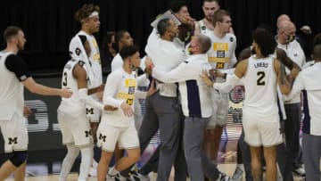 Michigan Wolverines head coach Juwan Howard is held back by his team and ejected against the Maryland Terrapins in the Big Ten tournament quarterfinals Friday, March 12, 2021 at Lucas Oil Stadium in Indianapolis.Michm Mary
