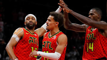ATLANTA, GA - NOVEMBER 21: Vince Carter #15 of the Atlanta Hawks reacts with Trae Young #11 and Dewayne Dedmon #14 after scoring his 25,000th NBA point in the final seconds of their 124-108 loss to the Toronto Raptors at State Farm Arena on November 21, 2018 in Atlanta, Georgia. NOTE TO USER: User expressly acknowledges and agrees that, by downloading and or using this photograph, User is consenting to the terms and conditions of the Getty Images License Agreement. (Photo by Kevin C. Cox/Getty Images)