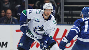 TORONTO, ON - FEBRUARY 29: Alexander Edler #23 of the Vancouver Canucks handles the puck against the Toronto Maple Leafs during an NHL game at Scotiabank Arena on February 29, 2020 in Toronto, Ontario, Canada. The Maple Leafs defeated the Canucks 4-2. (Photo by Claus Andersen/Getty Images)