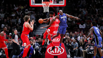The Orlando Magic's Bismack Biyombo (11) guards the Chicago Bulls' Justin Holiday (7) while he passes the ball to teammate Robin Lopez (42) during the second half at the United Center in Chicago on Wednesday, Dec. 20, 2017. The Bulls won, 112-94. (Armando L. Sanchez/Chicago Tribune/TNS via Getty Images)