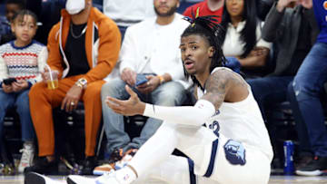 Mar 11, 2022; Memphis, Tennessee, USA; Memphis Grizzlies guard Ja Morant (12) looks to the official for a foul call after a drive to the basket during the second half against the New York Knicks at FedExForum. Mandatory Credit: Petre Thomas-USA TODAY Sports