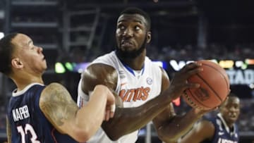 Apr 5, 2014; Arlington, TX, USA;Florida Gators center Patric Young (4) is defended by Connecticut Huskies guard Shabazz Napier (13) in the first half during the semifinals of the Final Four in the 2014 NCAA Mens Division I Championship tournament at AT&T Stadium. Mandatory Credit: Bob Donnan-USA TODAY Sports