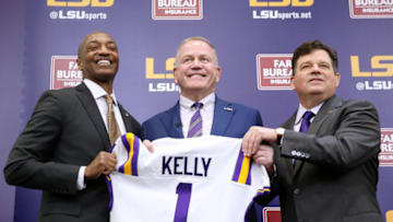 BATON ROUGE, LOUISIANA - DECEMBER 01: Brian Kelly (C) is introduced as the head football coach of the LSU Tigers by LSU President William F. Tate IV (L) and athletics director Scott Woodward during a news conference at Tiger Stadium on December 01, 2021 in Baton Rouge, Louisiana. (Photo by Jonathan Bachman/Getty Images)