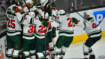 May 16, 2021; Las Vegas, Nevada, USA; Minnesota Wild players celebrate after Minnesota Wild center Joel Eriksson Ek (14) scored an overtime goal to defeat the Vegas Golden Knights 1-0 in game one of the first round of the 2021 Stanley Cup Playoffs at T-Mobile Arena. Mandatory Credit: Stephen R. Sylvanie-USA TODAY Sports