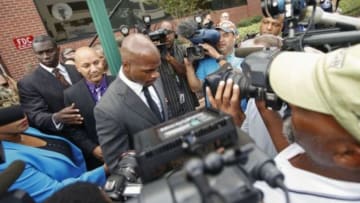 Oct 8, 2014; Conroe, TX, USA; Minnesota Vikings running back Adrian Peterson (middle) walks to his car after his arraignment at the Montgomery county courthouse. Mandatory Credit: Kevin Jairaj-USA TODAY Sports