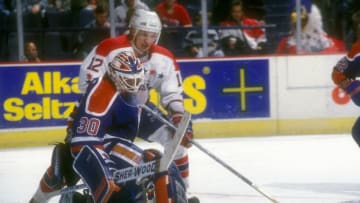LANDOVER, MD - FEBRUARY 15: Bill Ranford #30 of the Edmonton Oilers makes a save on a Peter Bondra #12 of the Washington Capitals shot a hockey game on February 15, 1994 at USAir Arena in Landover, Maryland. The game ended in a 2-2 overtime tie. (Photo by Mitchell Layton/Getty Images)