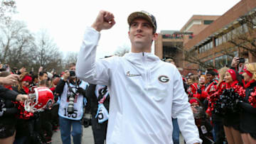Jan 15, 2022; Athens, Georgia, USA; Georgia Bulldogs quarterback Stetson Bennett (13) walks through fans at the Georgia Bulldogs National Championship Celebration at Sanford Stadium. Mandatory Credit: Brett Davis-USA TODAY Sports