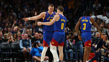 DENVER, CO - OCTOBER 22: Nikola Jokic #15 and Christian Braun #0 of the Denver Nuggets talk during a timeout in the game against the Oklahoma City Thunder at Ball Arena on October 22, 2022 in Denver, Colorado. NOTE TO USER: User expressly acknowledges and agrees that, by downloading and or using this Photograph, User is consenting to the terms and conditions of the Getty Images License Agreement. Mandatory Copyright Notice: Copyright 2022 NBAE (Photo by Justin Tafoya/Getty Images)