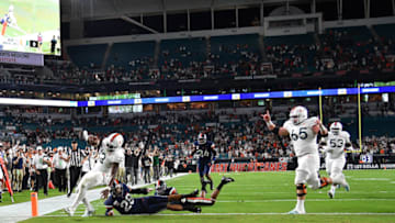 MIAMI, FLORIDA - OCTOBER 11: DeeJay Dallas #13 of the Miami Hurricanes runs for touchdown against the Virginia Cavaliers in the first half at Hard Rock Stadium on October 11, 2019 in Miami, Florida. (Photo by Mark Brown/Getty Images)