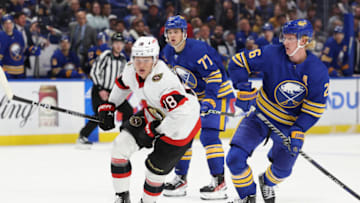 Oct 13, 2022; Buffalo, New York, USA; Ottawa Senators left wing Tim Stützle (18) and Buffalo Sabres defenseman Rasmus Dahlin (26) look for the puck during the third period at KeyBank Center. Mandatory Credit: Timothy T. Ludwig-USA TODAY Sports
