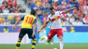 Jul 26, 2014; Harrison, NJ, USA; New York Red Bulls defender Armando (5) controls the ball in front of Arsenal midfielder Santi Cazorla (19) during the second half of a game at Red Bull Arena. The Red Bulls defeated Arsenal 1-0. Mandatory Credit: Brad Penner-USA TODAY Sports