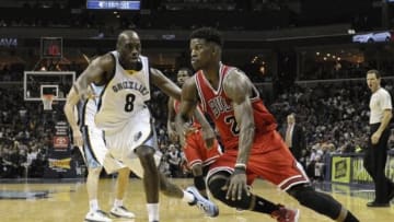 Dec 19, 2014; Memphis, TN, USA; Chicago Bulls guard Jimmy Butler (21) drives past Memphis Grizzlies guard Quincy Pondexter (8) during the game at FedExForum. Chicago Bulls beat Memphis Grizzlies 103-97. Mandatory Credit: Justin Ford-USA TODAY Sports