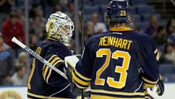 Oct 1, 2014; Buffalo, NY, USA; Buffalo Sabres center Sam Reinhart (23) congratulates goalie Jhonas Enroth (1) on a win against the Washington Capitals at First Niagara Center. Buffalo beats Washington 6 to 1. Mandatory Credit: Timothy T. Ludwig-USA TODAY Sports