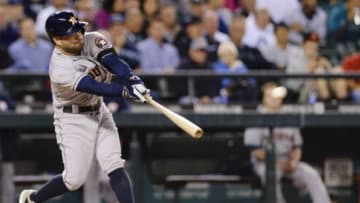 Sep 10, 2014; Seattle, WA, USA; Houston Astros second baseman Jose Altuve (27) hits an RBI double against the Seattle Mariners during the fifth inning at Safeco Field. Mandatory Credit: Steven Bisig-USA TODAY Sports