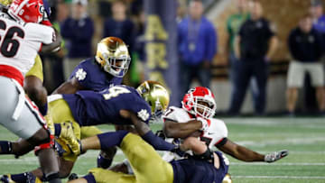 SOUTH BEND, IN - SEPTEMBER 09: Nick Chubb #27 of the Georgia Bulldogs gets tackled by a group of Notre Dame Fighting Irish defenders in the second quarter of a game at Notre Dame Stadium on September 9, 2017 in South Bend, Indiana. (Photo by Joe Robbins/Getty Images)