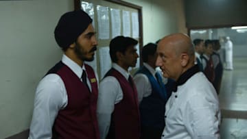 Dev Patel (left) as "Arjun" and Anupam Kher (right) as "Oberoi" in director Anthony Maras' HOTEL MUMBAI, a Bleecker Street release. Credit : Kerry Monteen / Bleecker Street