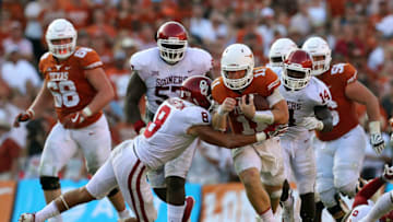 DALLAS, TX - OCTOBER 14: Kahlil Haughton #8 of the Oklahoma Sooners tries to tackle Sam Ehlinger #11 of the Texas Longhorns in the second half of a football game at Cotton Bowl on October 14, 2017 in Dallas, Texas. (Photo by Richard Rodriguez/Getty Images)