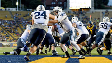 BERKELEY, CA - NOVEMBER 29: Christian Stewart #7 of the Brigham Young Cougars hands the ball off to Algernon Brown #24 against the California Golden Bears at California Memorial Stadium on November 29, 2014 in Berkeley, California. (Photo by Thearon W. Henderson/Getty Images)