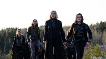 The 100 -- "The Blood of Sanctum" -- Image Number: HU613b_0310b.jpg -- Pictured (L-R): Jessica Harmon as Niylah, Lindsey Morgan as Raven, Eliza Taylor as Clarke and Lola Flanery as Madi -- Photo: Diyah Pera/The CW -- © 2019 The CW Network, LLC. All rights reserved.