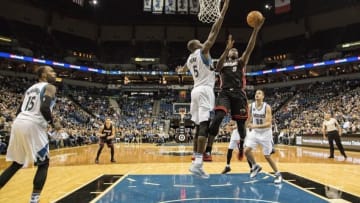 Nov 5, 2015; Minneapolis, MN, USA; Miami Heat forward Luol Deng (9) goes up for a layup past Minnesota Timberwolves center Gorgui Dieng (5) in the second half at Target Center. The Heat won 96-84. Mandatory Credit: Jesse Johnson-USA TODAY Sports