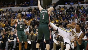 Feb 27, 2014; Indianapolis, IN, USA; Indiana Pacers guard George Hill (3) falls and hurts his shoulder in front of Milwaukee Bucks forward Ersan Ilyasova (7) at Bankers Life Fieldhouse. The Pacers won 101-96. Mandatory Credit: Brian Spurlock-USA TODAY Sports