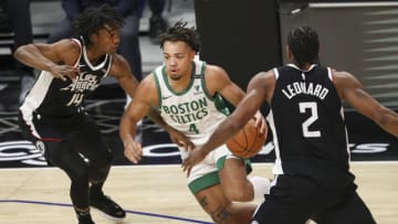 LOS ANGELES, CALIFORNIA - FEBRUARY 05: Carsen Edwards #4 of the Boston Celtics handles the ball defended by Terance Mann #14 of the LA Clippers at Staples Center on February 05, 2021 in Los Angeles, California. NOTE TO USER: User expressly acknowledges and agrees that, by downloading and or using this photograph, User is consenting to the terms and conditions of the Getty Images License Agreement. (Photo by Meg Oliphant/Getty Images)