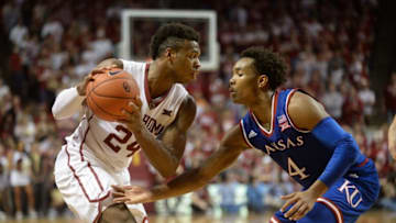 Feb 13, 2016; Norman, OK, USA; Oklahoma Sooners guard Buddy Hield (24) handles the ball against Kansas Jayhawks guard Devonte