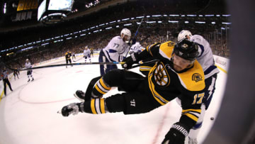 BOSTON, MA - MAY 4: Cedric Paquette #13 of the Tampa Bay Lightning checks Ryan Donato #17 of the Boston Bruins into the boards during the third period of Game Four of the Eastern Conference Second Round during the 2018 NHL Stanley Cup Playoffs at TD Garden on May 4, 2018 in Boston, Massachusetts.(Photo by Maddie Meyer/Getty Images)