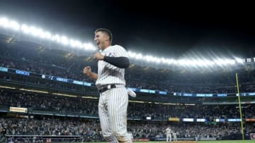 NEW YORK, NY - MAY 09: Gleyber Torres #25 of the New York Yankees jumps from the dugout after teamamte Aaron Judge hit a two run home run in the eighth inning against the Boston Red Sox at Yankee Stadium on May 9, 2018 in the Bronx borough of New York City. (Photo by Elsa/Getty Images)