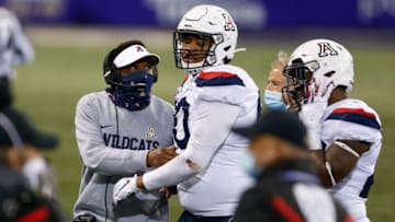 Nov 21, 2020; Seattle, Washington, USA; Arizona Wildcats head coach Kevin Sumlin comforts defensive lineman Trevon Mason (90) after a touchdown by the Washington Huskies during the third quarter at Alaska Airlines Field at Husky Stadium. Mandatory Credit: Jennifer Buchanan-USA TODAY Sports